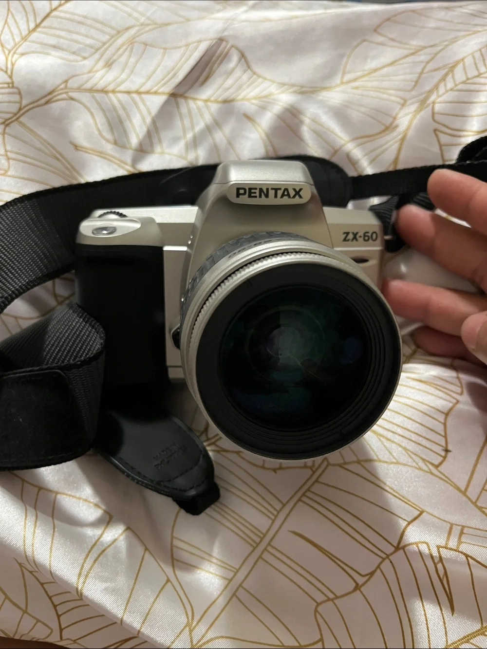 Pentax Silver and Black DSLR with 28-90mm Zoom Lens and Branded Strap